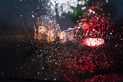 Close-up of wet car window during rainy season