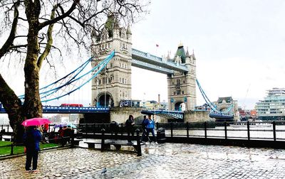 People on bridge over river