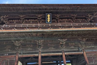 Low angle view of text on building roof