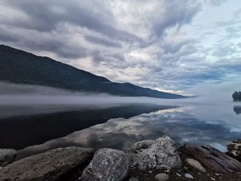 Scenic view of lake and mountains against sky