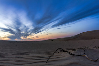 Scenic view of desert against dramatic sky