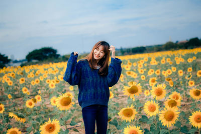 Beautiful young woman standing on field