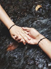 High angle view of hands in water