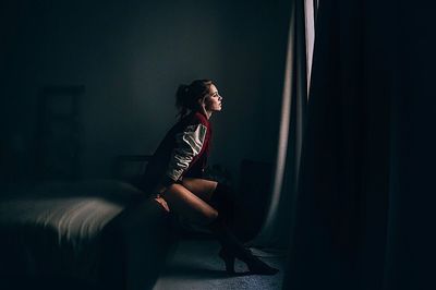 Woman sitting on chair at night