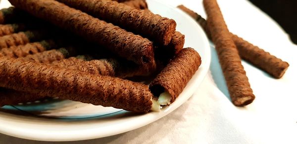 Close-up of chocolate sticks in plate on table