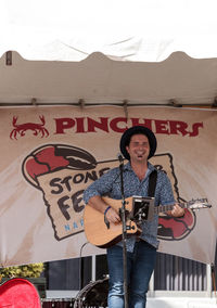 Portrait of a young man playing guitar