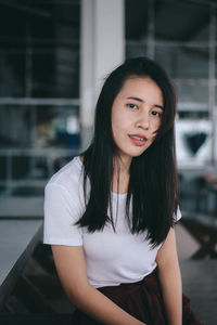 Portrait of a smiling young woman standing outdoors