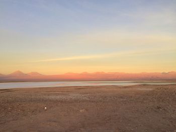 Scenic view of beach against sky during sunset