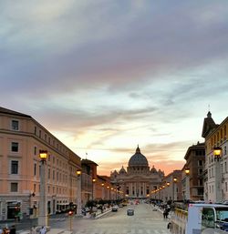 Buildings in city at sunset