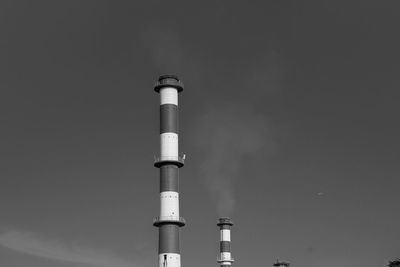 Low angle view of smoke stack against sky