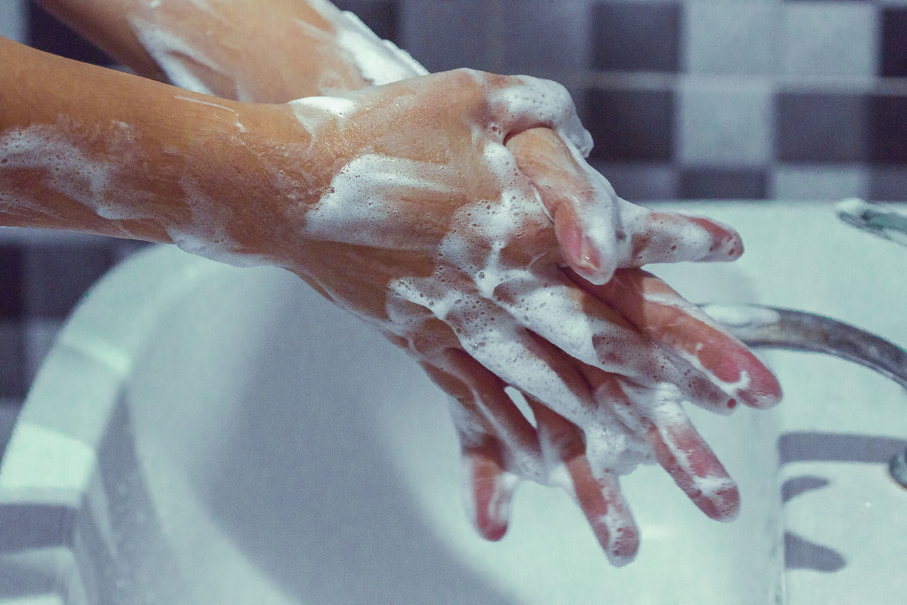 CLOSE-UP OF PERSON HAND WITH WATER