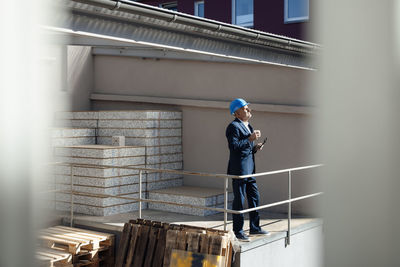 Senior businessman standing at construction site