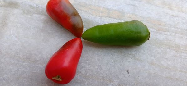 Close-up of red chili peppers on table