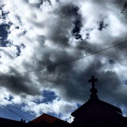 Low angle view of building against cloudy sky