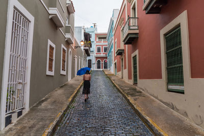 Rear view of woman standing on street