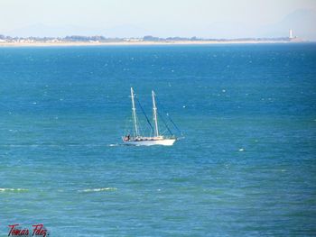 Sailboat sailing in sea against sky