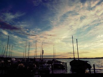 Boats in sea at sunset
