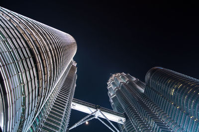 Directly below shot of petronas towers against clear sky