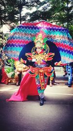 Multi colored umbrella in traditional clothing during festival