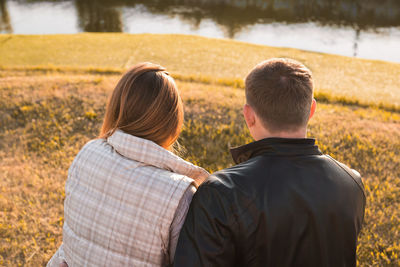 Rear view of couple on field