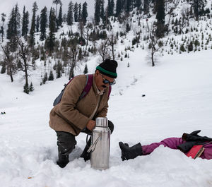 Rear view of person on snow covered land