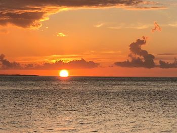 Scenic view of sea against orange sky