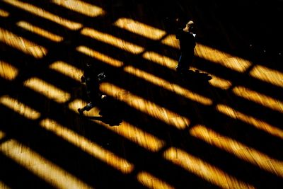 High angle view of people walking on hardwood floor