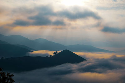 Low angle view of silhouette mountains against sky during sunset