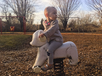 Full length of girl sitting on field