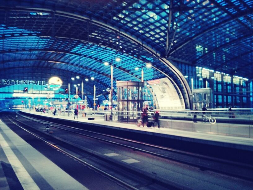 railroad station, indoors, architecture, public transportation, built structure, transportation, large group of people, railroad station platform, travel, person, lifestyles, arch, men, rail transportation, incidental people, city life, ceiling, transportation building - type of building, passenger