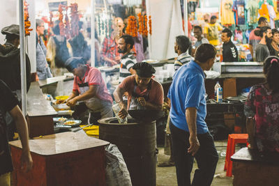 People working at market stall