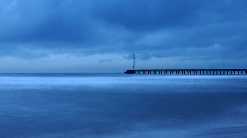 Pier over sea against sky
