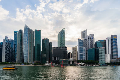 View of skyscrapers against cloudy sky