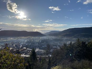 High angle view of townscape by mountains against sky