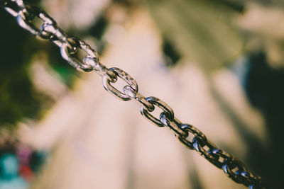 Close-up of chain hanging on rope