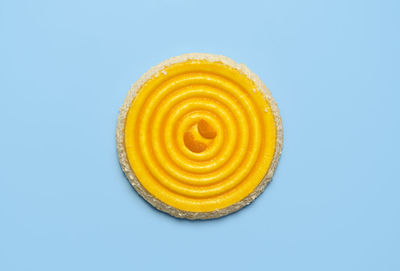 Close-up of lemon slice against blue background