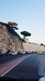 Car on road against sky in city