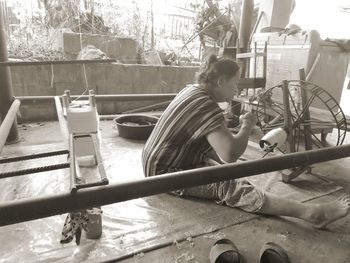 Side view of woman sitting on bicycle