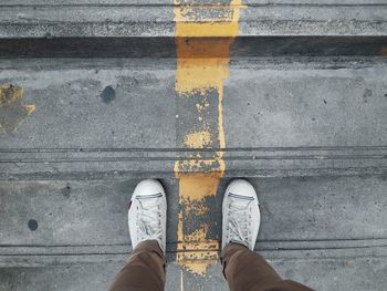 Low section of man standing on floor