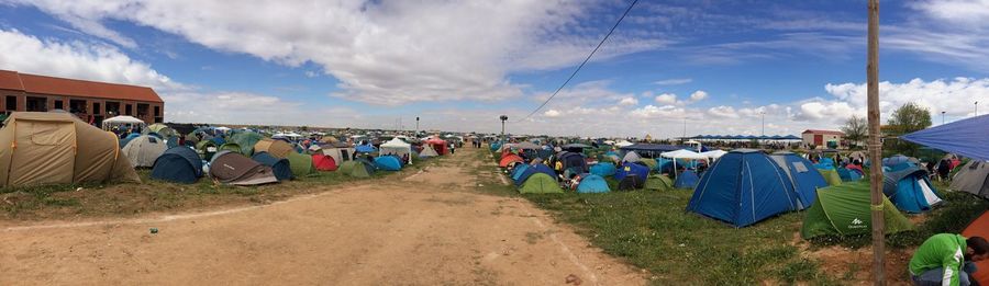 Panoramic view of people against sky