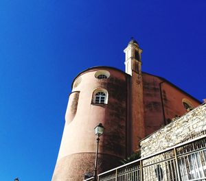 Low angle view of buildings against clear blue sky