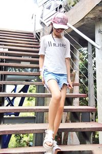 Young woman standing on footbridge