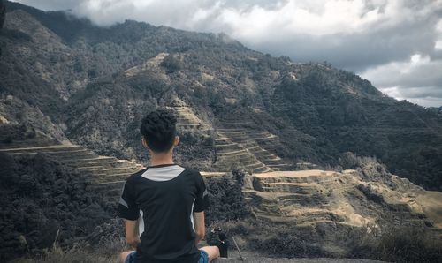 Rear view of man looking at mountains