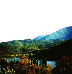 Scenic view of lake and mountains against clear sky