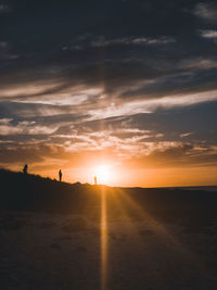 Scenic view of beach against sky during sunset