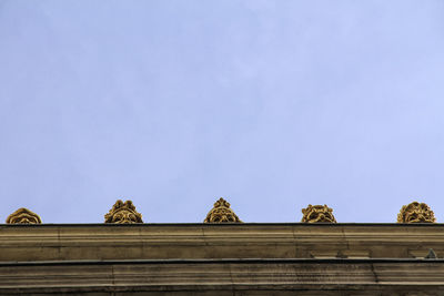 Low angle view of carving on roof against sky