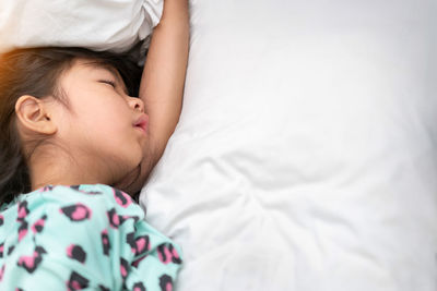 High angle view of baby sleeping on bed