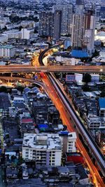 High angle view of illuminated street amidst buildings in city