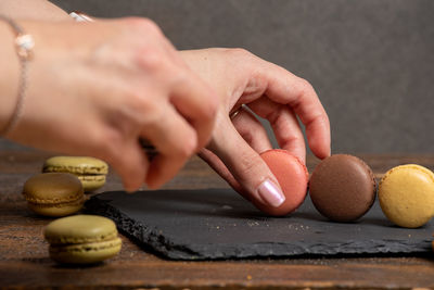 Close-up of woman preparing food on table