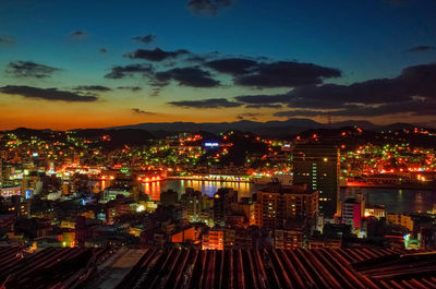 High angle view of illuminated buildings in city at night